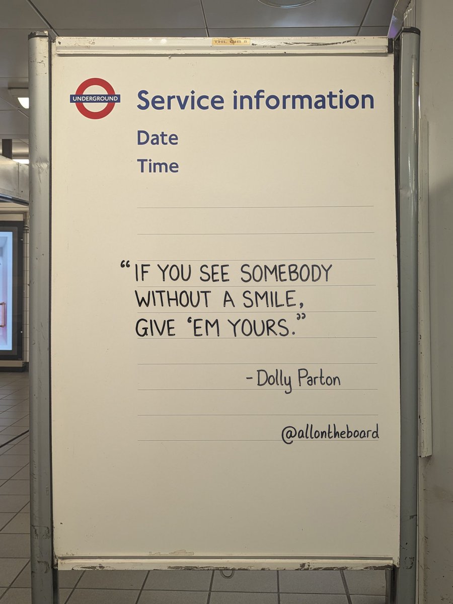 Hand-lettered board quoting Dolly Parton: if you see somebody without a smile, give ’em yours.